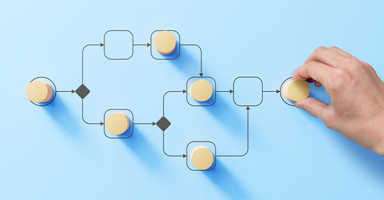 Convolutional_3 • Andrew Roche AI Hand placing a wooden token on a process flow diagram with arrows and nodes on a light blue background, symbolizing workflow steps.